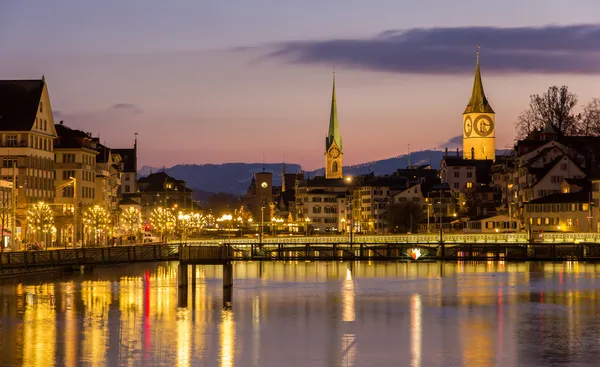 Zurich on banks of Limmat river at winter evening — Stock Photo, Image