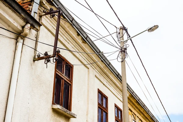 Electric line on the old house wall. — Stock Photo, Image