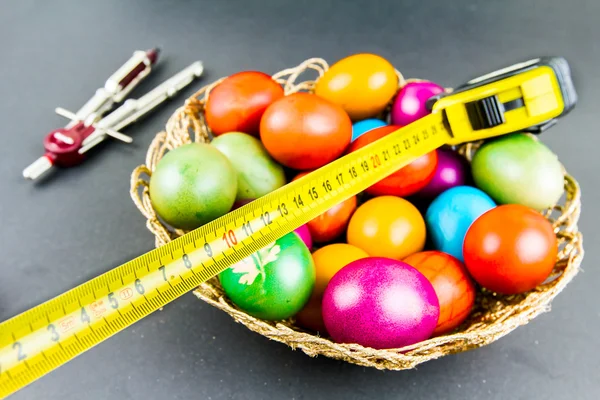 Decorated Easter eggs in a engineer woven basket — Stock Photo, Image