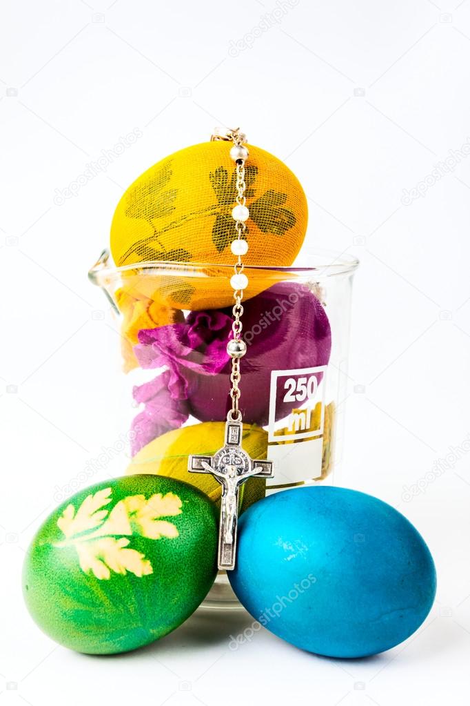 Easter eggs with rosary on lab glass