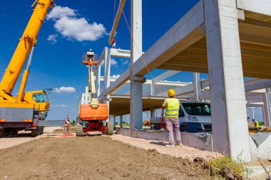 Çalışan mobil vinç halat boyu derleme büyük inşaat için beton kiriş yönetmek için yardımcı oluyor.