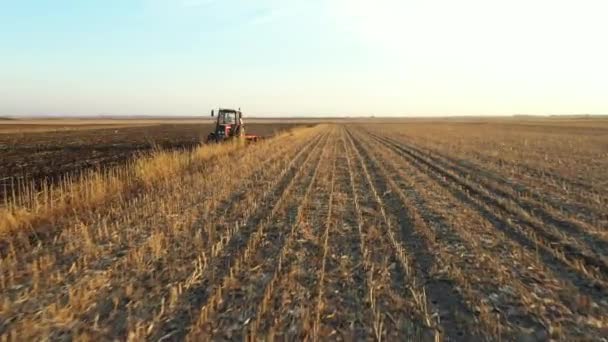 Dolly Orbit Move Shot Tractor Pulling Machine Harrowing Arable Field — Stock Video