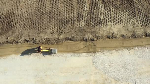 Top View Worker Compacting Foundation Using Vibration Plate Compactorabove Top — Stock Video