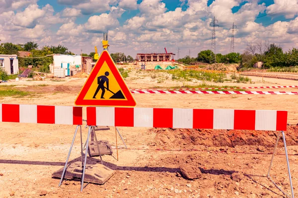 Work in progress, triangle sign with boundary, caution symbol, trench is on construction site.