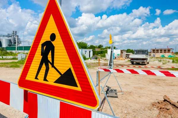 Work in progress, triangle sign with boundary, caution symbol, trench is on construction site.