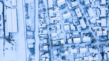 Üst manzara evlerin çatılarında kardan beyaz, kışın soğuk şehir manzarası..  
