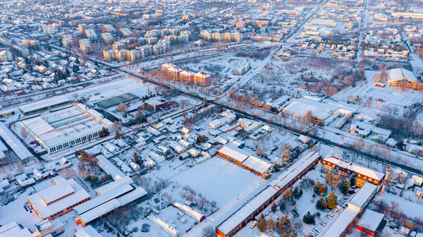 Aerial view is on the roofs of houses white of snow, frosty cityscape in the winter time.