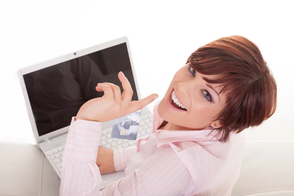Happy beautiful woman holding credit card and laptop Stock Image
