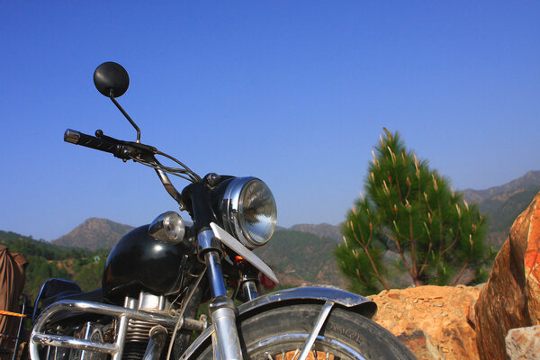 Indian landscape with a Royal Enfield motorcycle in the Himalayas