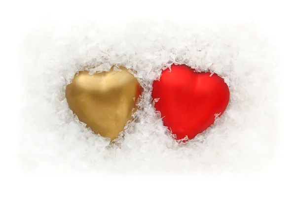 Gold and red two hearts in the snow - on a white background — Stock Photo, Image