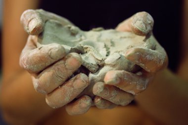 Raw clay in the hands of women clipart