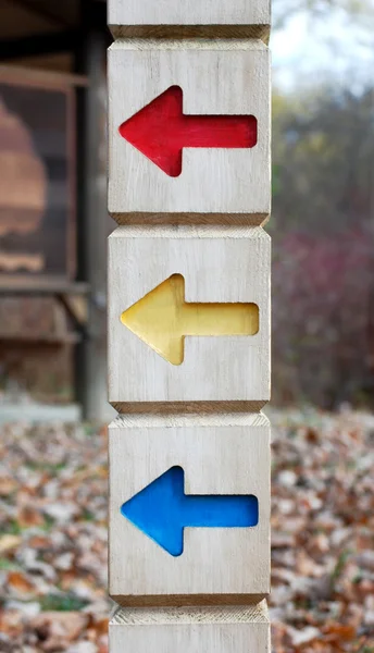 Directional sign with red yellow and blue arrows — Stock Photo, Image