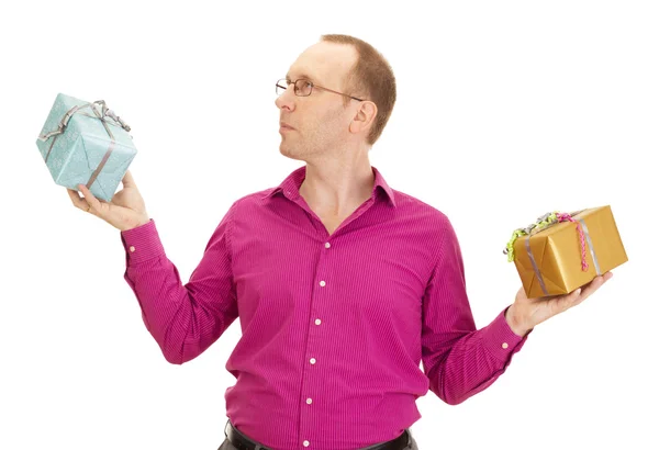 A business person juggling with two colorful gifts — Stock Photo, Image