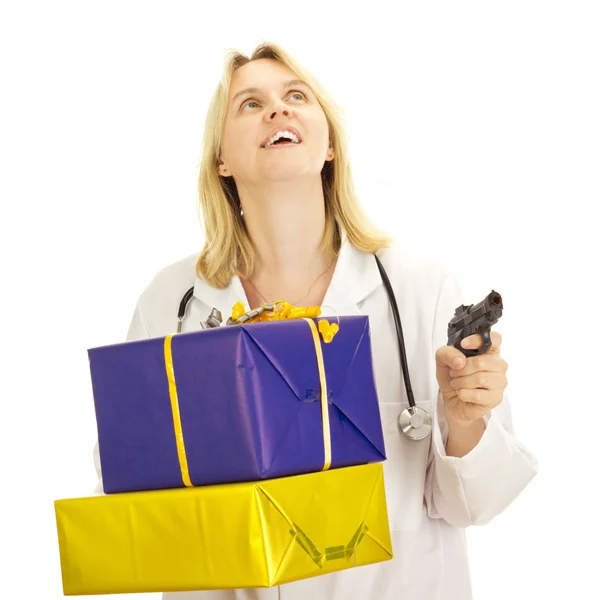 Medical doctor with gifts and a gun — Stock Photo, Image