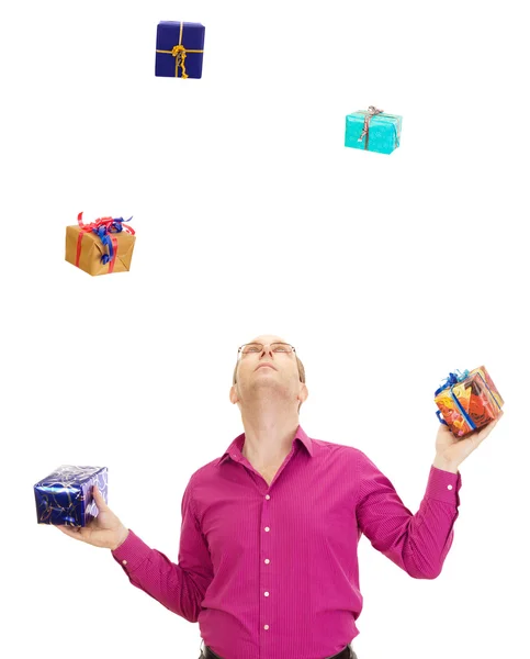 A business person juggling with some colorful gifts — Stock Photo, Image