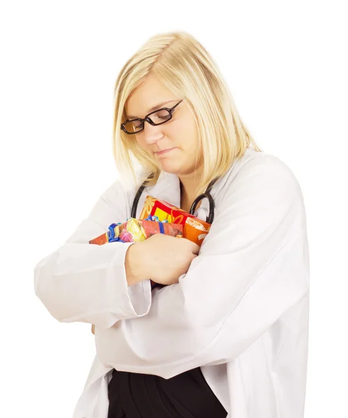 Medical doctor hugging some gifts — Stock Photo, Image