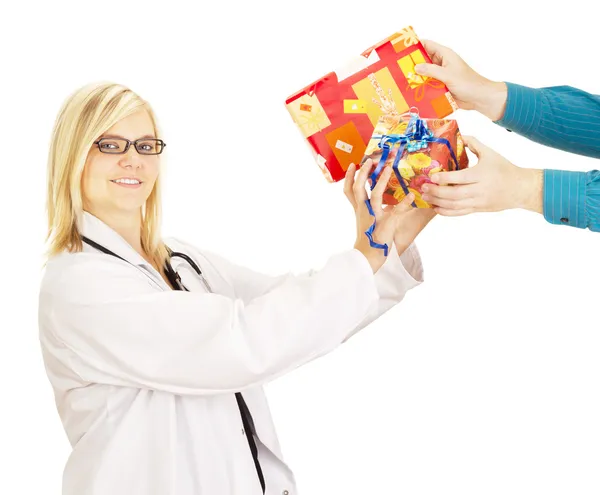 Medical doctor grabbing two gifts — Stock Photo, Image