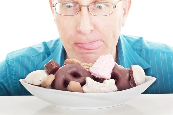 Person eating some delicate gingerbreads — Stock Photo, Image