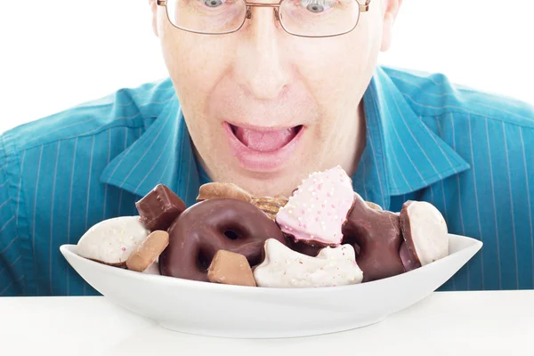 Person eating some delicate gingerbreads — Stock Photo, Image