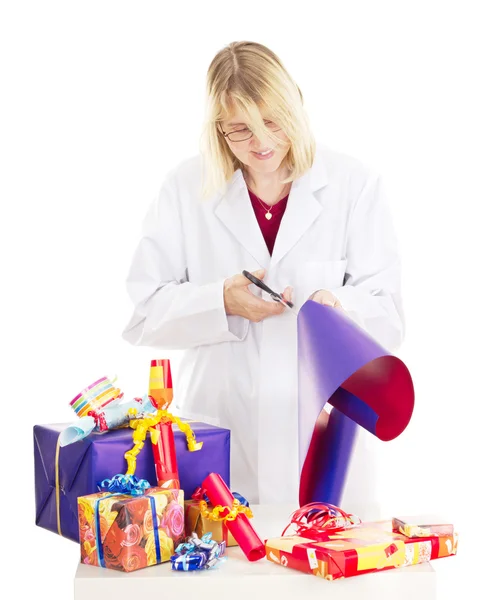 Person packaging some colorful gifts — Stock Photo, Image