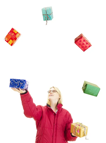 Woman juggling with some colorful gifts — Stock Photo, Image