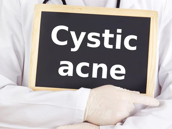 Doctor shows information on blackboard: cystic acne — Stock Photo, Image