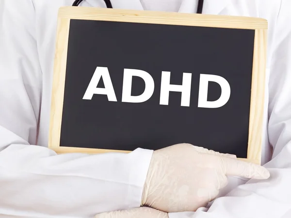 Doctor shows information on blackboard: adhd — Stock Photo, Image