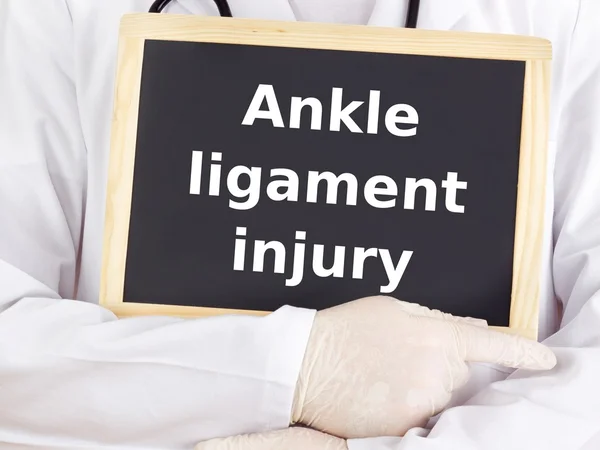 Doctor shows information: ankle ligament injury — Stock Photo, Image