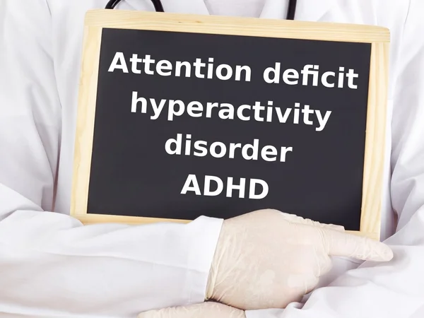 Doctor shows information on blackboard: adhd — Stock Photo, Image