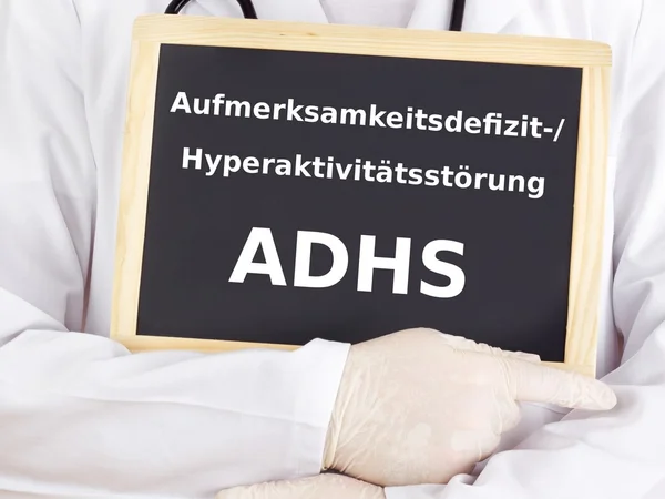 Doctor shows information on blackboard: adhs — Stock Photo, Image