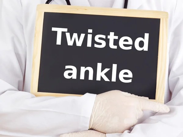 Doctor shows information on blackboard: twisted ankle — Stock Photo, Image