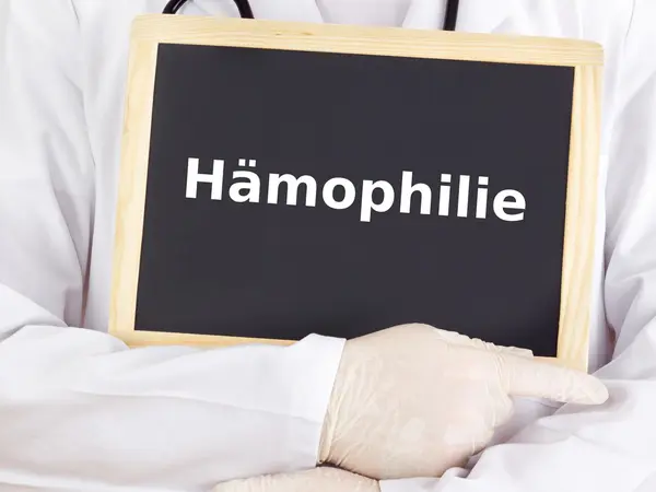 Doctor shows information on blackboard: hemophilia — Stock Photo, Image