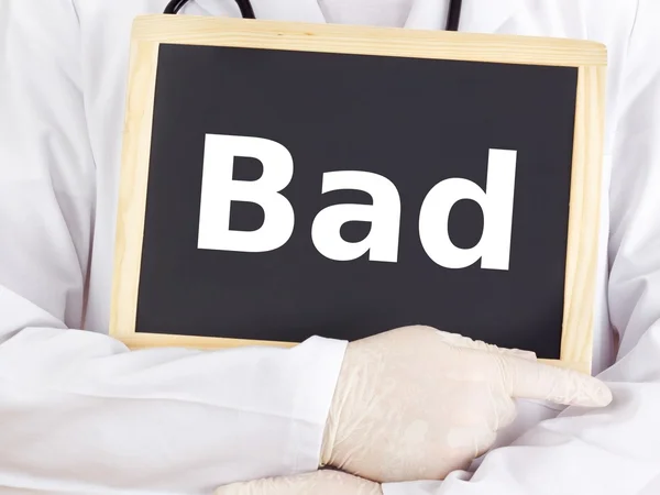 Doctor shows information on blackboard: bad — Stock Photo, Image