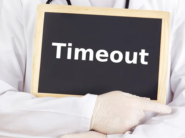 Doctor shows information on blackboard: timeout — Stock Photo, Image