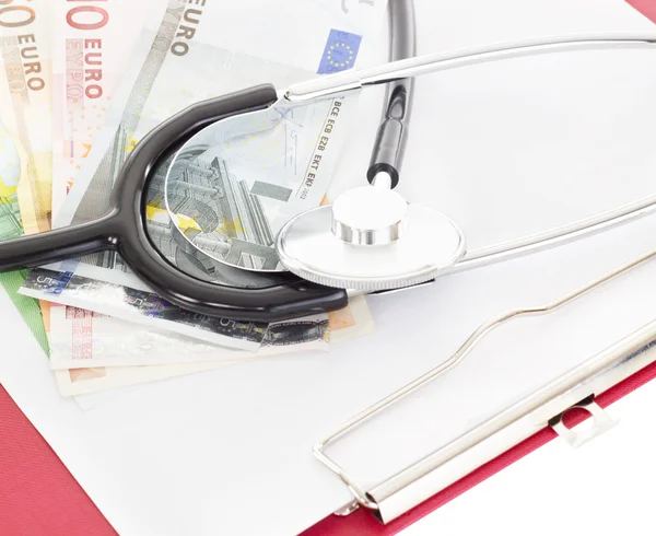 Money and stethoscope on clipboard — Stock Photo, Image