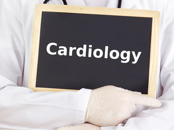 Doctor shows information on blackboard: cardiology — Stock Photo, Image