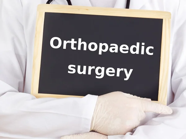 Doctor shows information: orthopaedic surgery — Stock Photo, Image