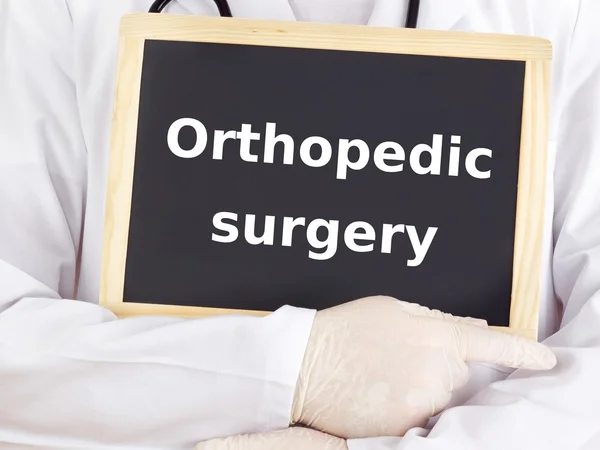 Doctor shows information: orthopedic surgery — Stock Photo, Image