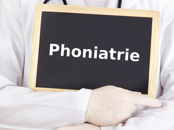 Doctor shows information on blackboard: phoniatrics — Stock Photo, Image