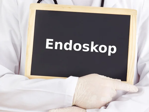 Doctor shows information on blackboard: endoscope — Stock Photo, Image
