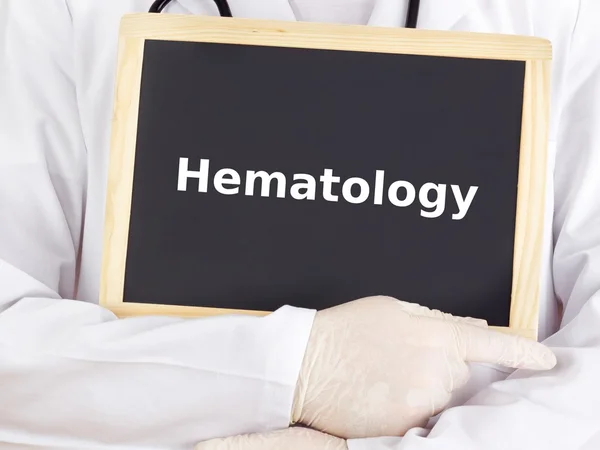 Doctor shows information on blackboard: hematology — Stock Photo, Image