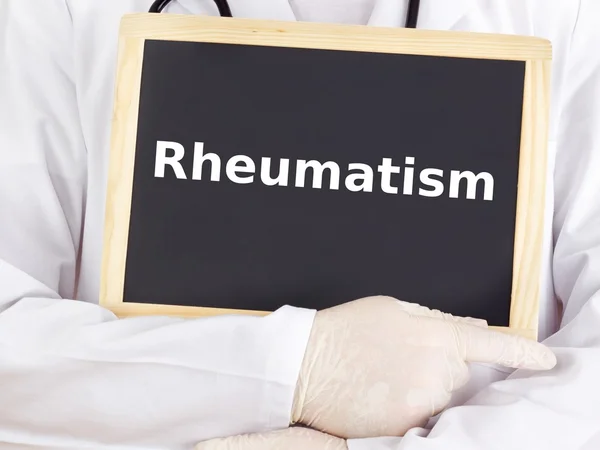 Le médecin montre des informations sur le tableau noir : rhumatisme — Photo