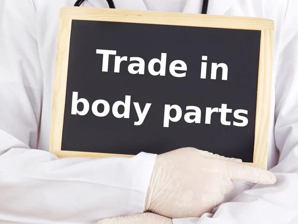 Doctor shows information: trade in body parts — Stock Photo, Image