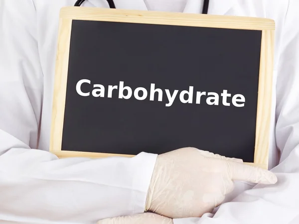 Doctor shows information on blackboard: carbohydrate — Stock Photo, Image