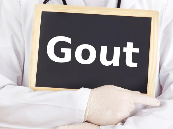 Doctor shows information on blackboard: gout — Stock Photo, Image