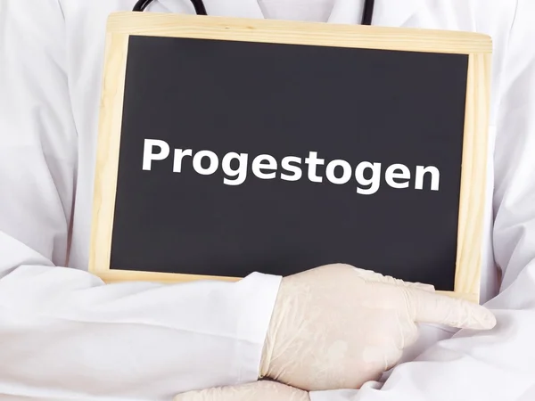 Doctor shows information on blackboard: progestogen — Stock Photo, Image