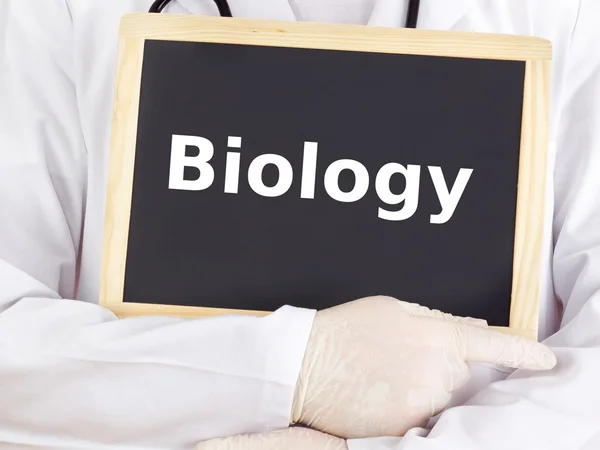 Doctor shows information on blackboard: biology — Stock Photo, Image