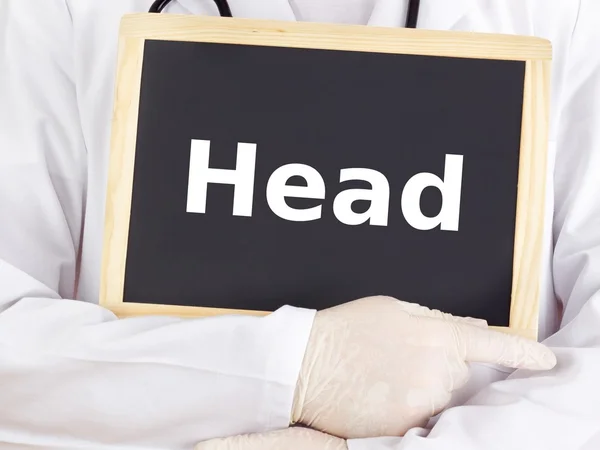 Doctor shows information on blackboard: head — Stock Photo, Image