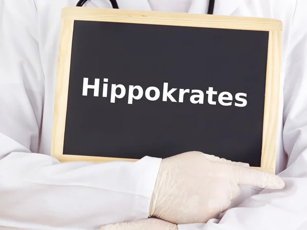 Doctor shows information on blackboard: hippocrates — Stock Photo, Image