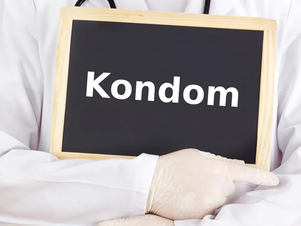Doctor shows information on blackboard: condom — Stock Photo, Image